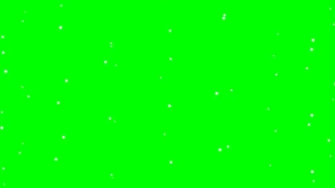 White snow particles falling slowly on a bright green chroma key Stock Footage 348075731