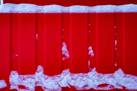 White snow on a red construction Fotos de archivo