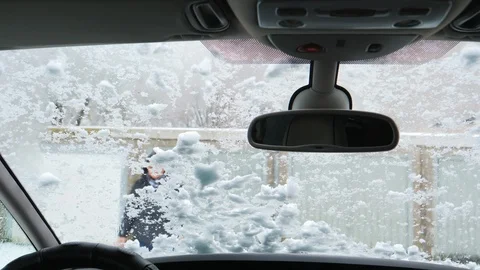 White Snow on windshield Man greeting his hand and looking at the camera Video stock 95795641