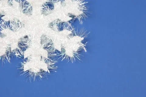 White snowflake on blue background Stock Photos