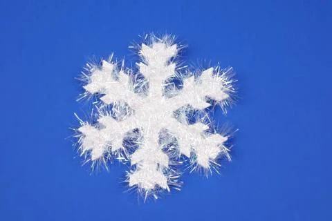 White snowflake on blue background Stock Photos