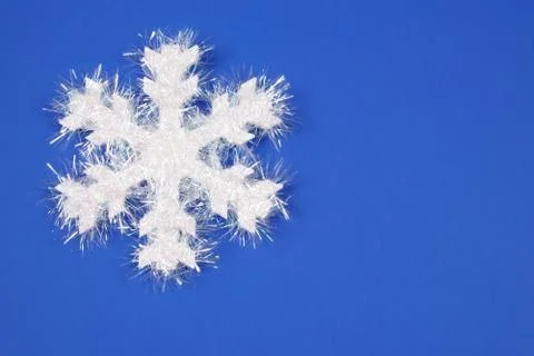 White snowflake with blue background Stock Photos