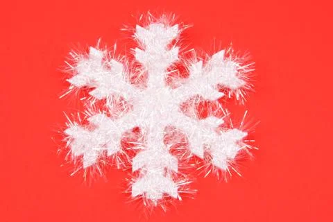 White snowflake on red background Foto stock