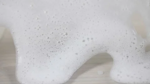 White soap bubble foam flowing on clear glass wall background backdrop Stock Footage 220951945