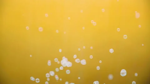 White soap bubbles flutter on a yellow background Stockbeeldmateriaal 137174607