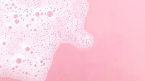 White soap foam bubbles on pink background, skincare cleansing and hygiene .. Stock Photos
