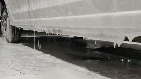 White soap sud falling down from car door during car wash procedure at night Stock Footage 161013351
