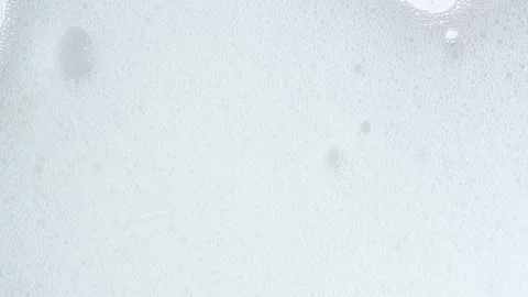 White soap suds flowing down window glass, close up. Taking a shower. Clean.. Stock Footage 269326326