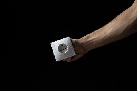 White socket on a black background. Flush-mounted white socket. Stock Photos