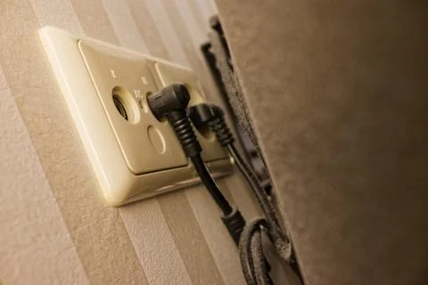 White socket panel with uncommon ports on a striped wall Stock Photos