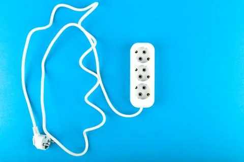 White socket with wire. View from above. on a blue background. White socket a Foto stock