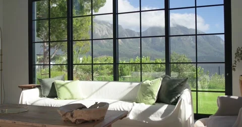 White sofa is catching moving light by window while camera is panning right, Stock Footage 345063884