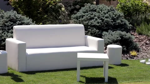 White sofa in the open yard, summer time Stock Footage 143928900