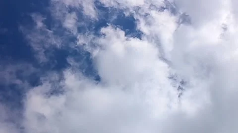 White soft clouds drifting across a clear blue sky daytime atmosphere Vídeo Stock 338250860