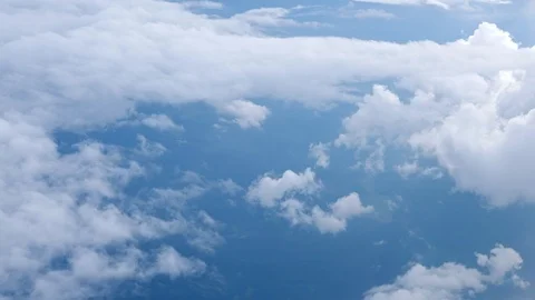 White soft fluffy clouds over the green landscape, aerial view from the plane. Stock Footage 112146189