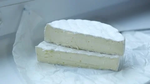 White soft moldy Camembert cheese piece cut with knife close up Stock Footage 302104320
