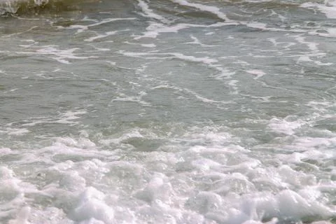 White soft wave rolling splash on empty tropical sandy beach in sunny day Stock Photos