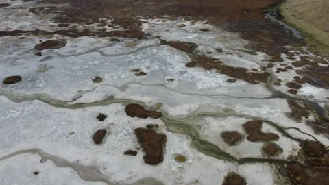 White soil brown sponge bogs and a thin stream of green water  Stock Footage 251785290