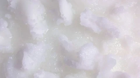 White solid coconut oil pieces circle rotation close up Stock Footage 262231283