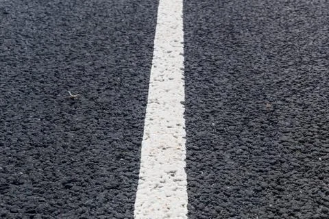 White solid line. Road marking on an asphalt road Stock Photos