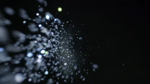 White sparkle glitter fly's upward and sprinkles into frame creating hyperspace Stock Footage 153917907