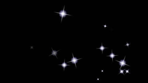 White sparkling stars on black background. Glowing light particles overlay for Видео 340607744