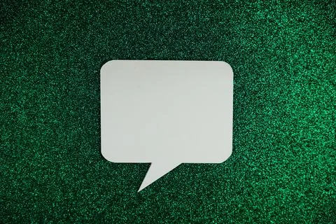 White Speech bubble mockup top view on green glitter background Stock Illustration