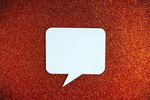 White Speech bubble mockup top view on orange glitter background Stock Photos
