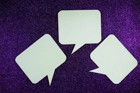 White Speech bubble mockup top view on purple glitter background Stock Photos