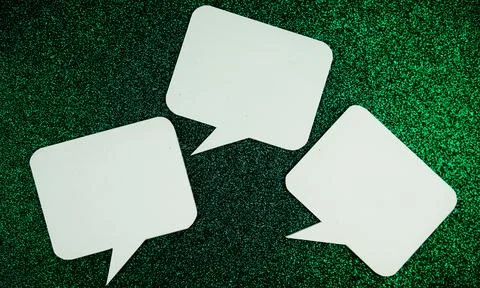 White Speech bubble mockup top view on green glitter background Stock Photos
