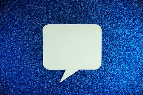 White Speech bubble mockup top view on blue glitter background Stock Photos