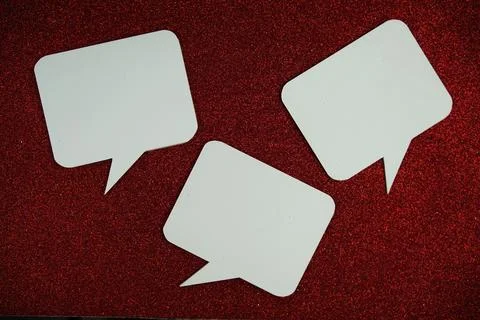 White Speech bubble mockup top view on red glitter background Stock Photos