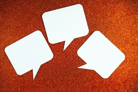 White Speech bubble mockup top view on orange glitter background Stock Photos