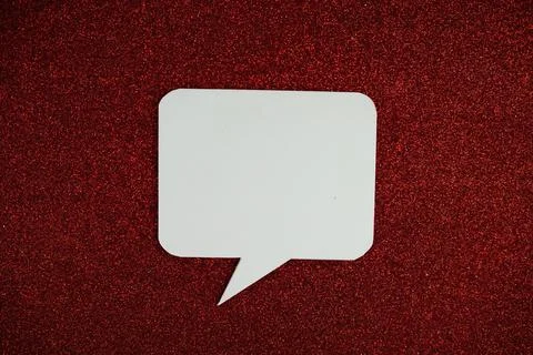 White Speech bubble mockup top view on red glitter background Stock Photos