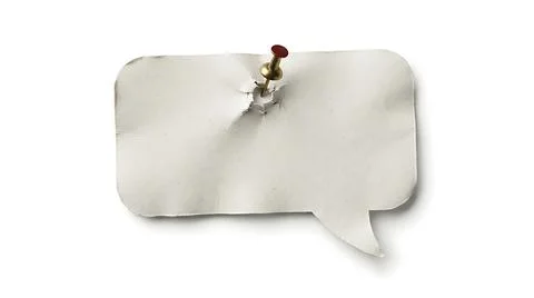 White speech bubble paper cutout pinned to a wall for communication and mes.. Stock Photos