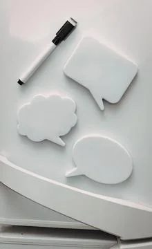 White speech bubbles and marker on white surface Stock Photos
