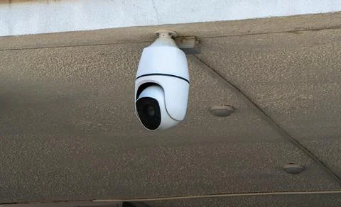 White Speed Dome CCTV Camera Mounted on Building Ceiling Stock Photos