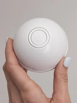 White spherical cat toy held in two hands variant Stock Photos