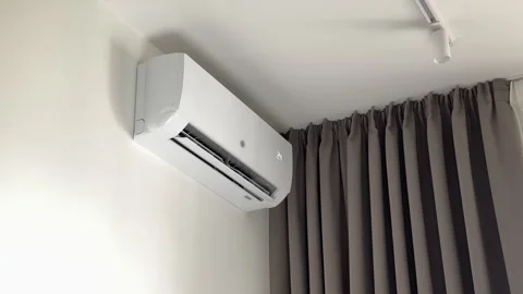White split system air conditioner operating on a wall during domestic vent.. Stock-Footage 347512872