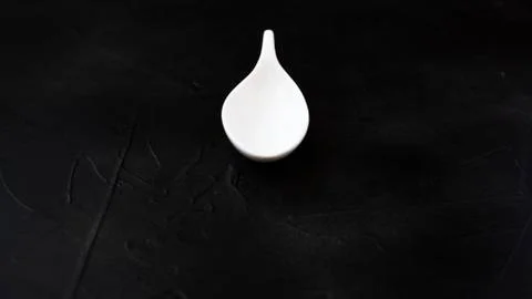 White spoon on black background. Stock Photos