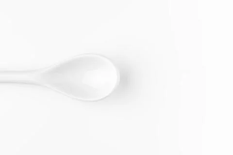 White spoon isolated on a white surface Stock Photos