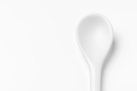 White spoon isolated on a white surface Stock Photos