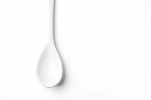 White spoon isolated on a white surface Stock Photos