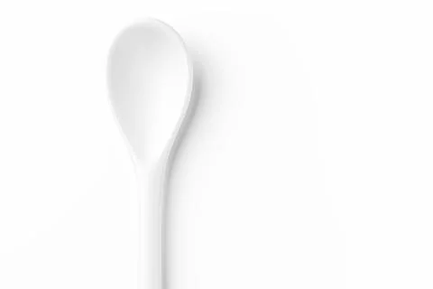 White spoon isolated on a white surface Stock Photos