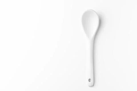 White spoon isolated on a white surface Stock Photos