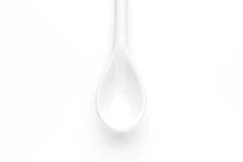 White spoon isolated on a white surface Stock Photos