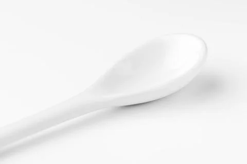 White spoon isolated on a white surface Stock Photos