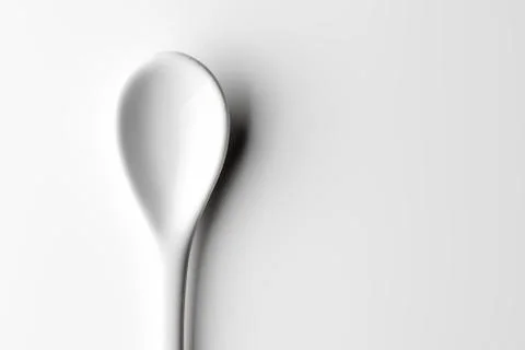 White spoon isolated on a white surface Stock Photos