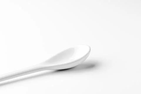 White spoon isolated on a white surface Stock Photos