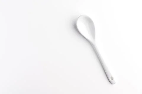 White spoon isolated on a white surface Stock Photos
